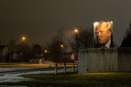 A photograph of president-elect Donald J. Trump, lit up with flood lights, in a suburban Iowa backyard. (Photo: Tony Webster/flickr)
